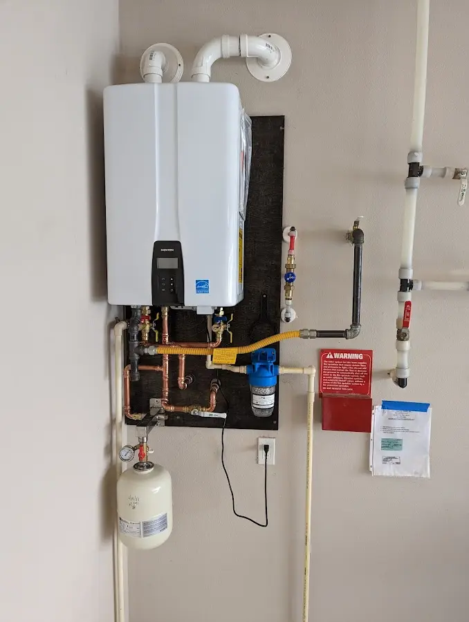 Professional plumber installing copper piping in a Ghent home